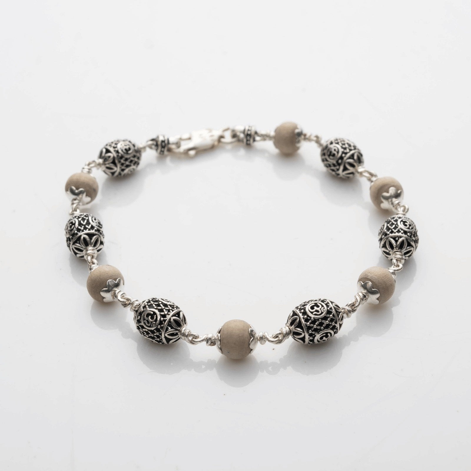 Tulsi With Silver Oval Om Beads Bracelet