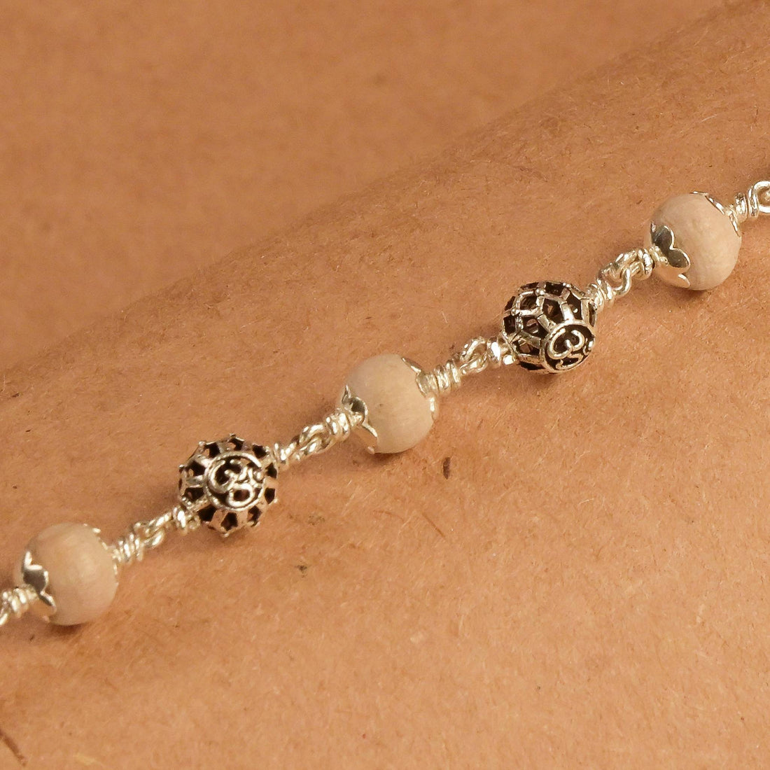 Tulsi with Round Om Beads Silver Bracelet